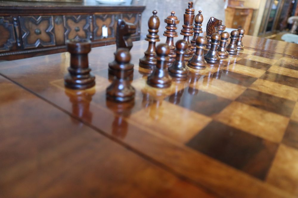 A George III style walnut sofa / games table with sliding reversible top, includes chess and backgammon pieces, width 94cm depth 60cm